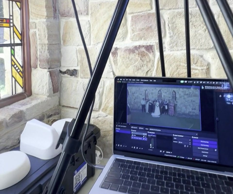 Wedding live stream running on a laptop beside the SyncSource box